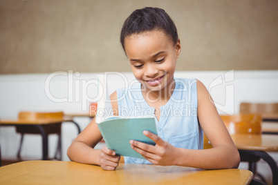 Smiling student reading a book