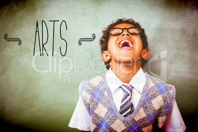 Arts against boy laughing in front of blackboard