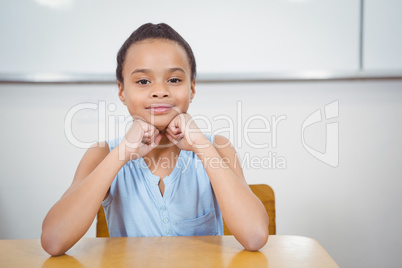 Smiling student resting head in her hands