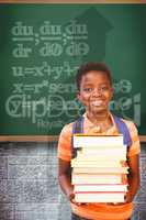 Composite image of cute little boy carrying books in library