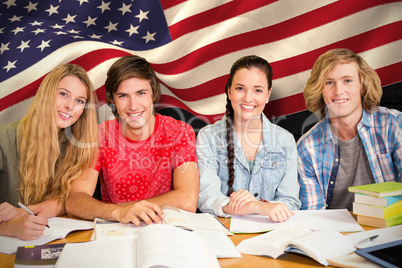 Composite image of college students doing homework in library