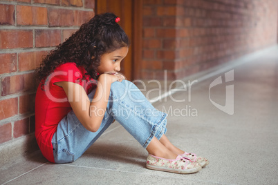 Upset lonely girl sitting by herself