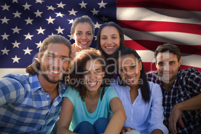 Composite image of smiling friends in the park