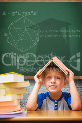 Composite image of cute boy with book on head