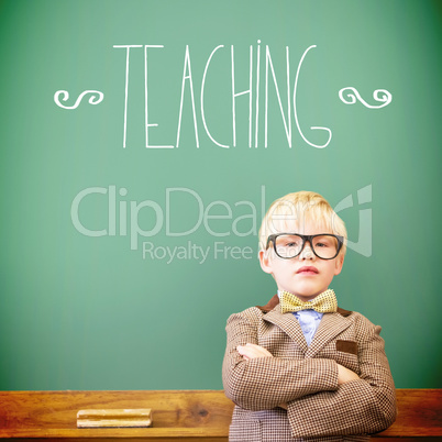 Teaching against cute pupil dressed up as teacher in classroom