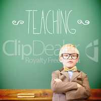 Teaching against cute pupil dressed up as teacher in classroom