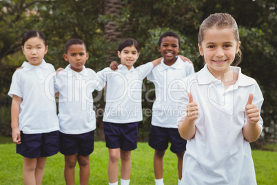 Student standing with thumbs up