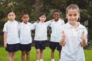 Student standing with thumbs up