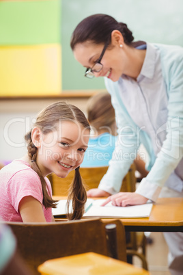 Teacher helping a pupil during class