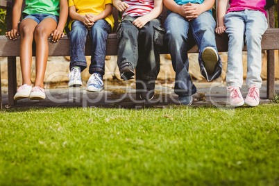 Close up view of classmates sitting on bench