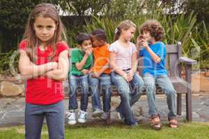 Upset child standing away from group