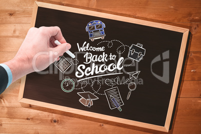 Composite image of hand writing with a white chalk