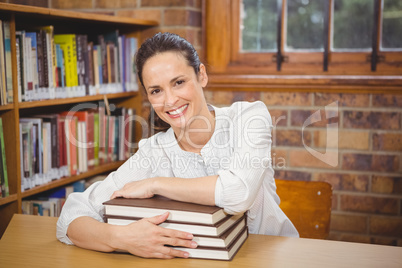 Teacher holding large books