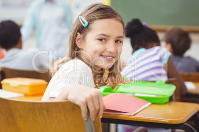 Pupil smiling at camera during class