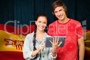 Composite image of smiling classmates with tablet pc