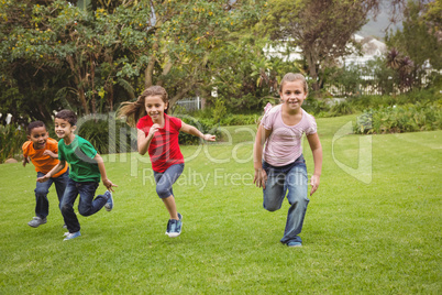Happy kids running across the grass