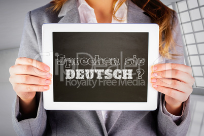 Composite image of businesswoman showing tablet