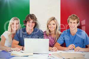 Composite image of a group of students with a laptop look into t