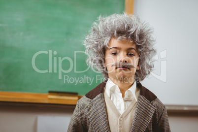 Cute pupil dressed up like Einstein in a classroom