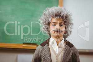 Cute pupil dressed up like Einstein in a classroom