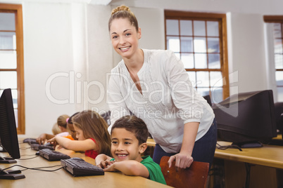 Teacher helping a student using a computer