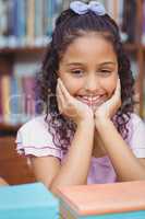 Pupil smiling at camera in library