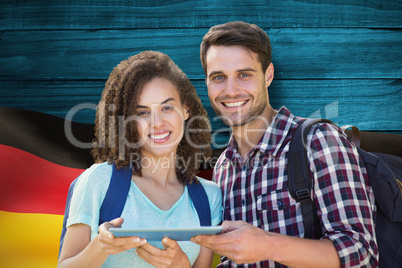 Composite image of students using tablet pc