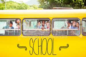 School against cute pupils smiling at camera in the school bus