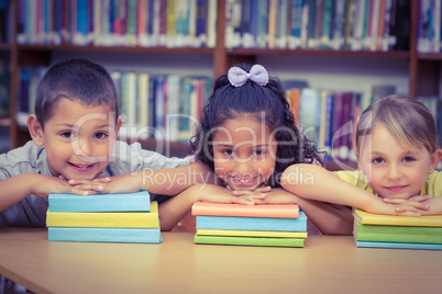 Pupils smiling at camera in library