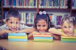 Pupils smiling at camera in library