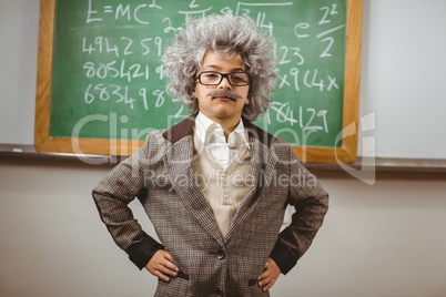 Little Einstein posing in front of chalkboard