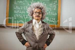 Little Einstein posing in front of chalkboard