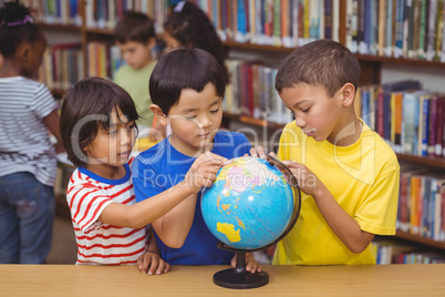 Pupils in library with globe Pupils in library with globe