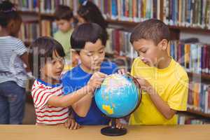 Pupils in library with globe