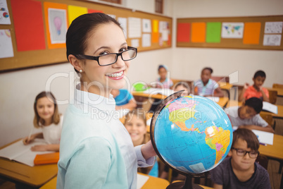 Teacher showing pupils a globe