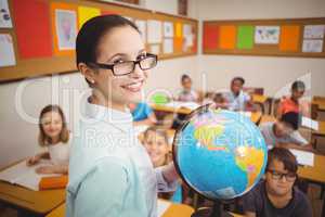 Teacher showing pupils a globe