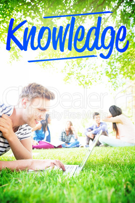 Knowledge against happy student using his laptop outside