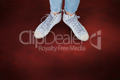 Composite image of woman wearing trainers