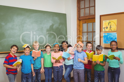 Students standing with books on their heads