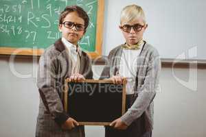 Pupils dressed up as teachers holding chalkboard