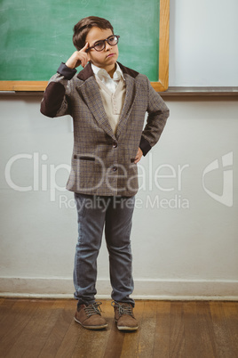 Pupil dressed up as teacher thinking in front of chalkboard