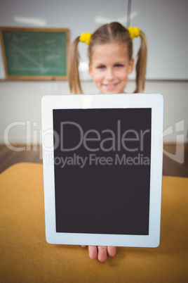 Smiling pupil showing tablet to camera