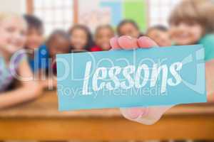 Lessons against cute pupils smiling at camera in classroom