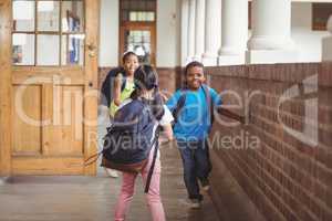 Happy pupils running around the corridor