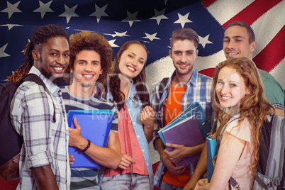 Composite image of smiling group of students holding folders