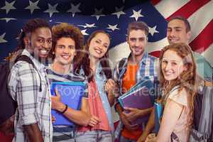 Composite image of smiling group of students holding folders