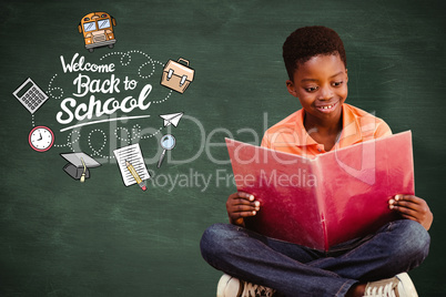 Composite image of cute boy reading book in library