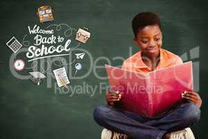 Composite image of cute boy reading book in library