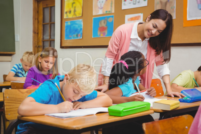 Smiling teacher helping a student