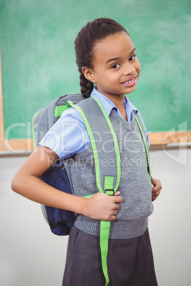 Student smiling and wearing a school bag